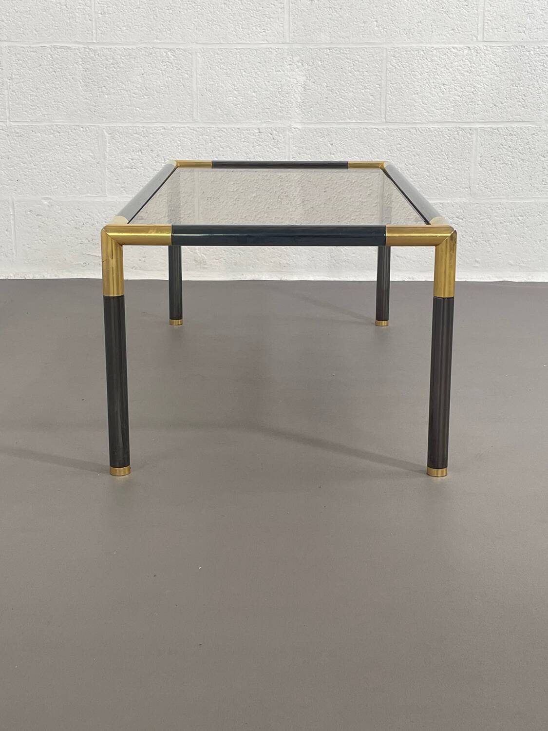 Gunmetal gold metal and smoked glass coffee table from the 70s