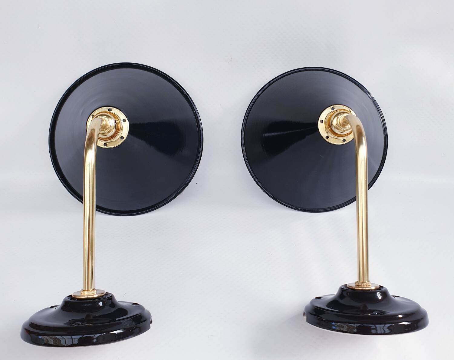 Pair of antique black enamelled sheet metal wall lights
