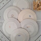 7 mismatched antique dessert plates accompanied by a pie dish