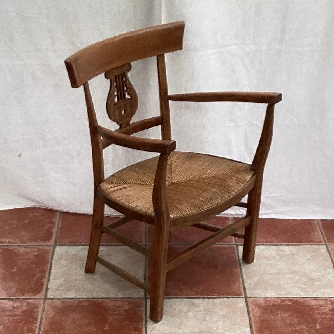 Light wood armchair seated in vintage straw dimension: height -78cm- width -54cm-