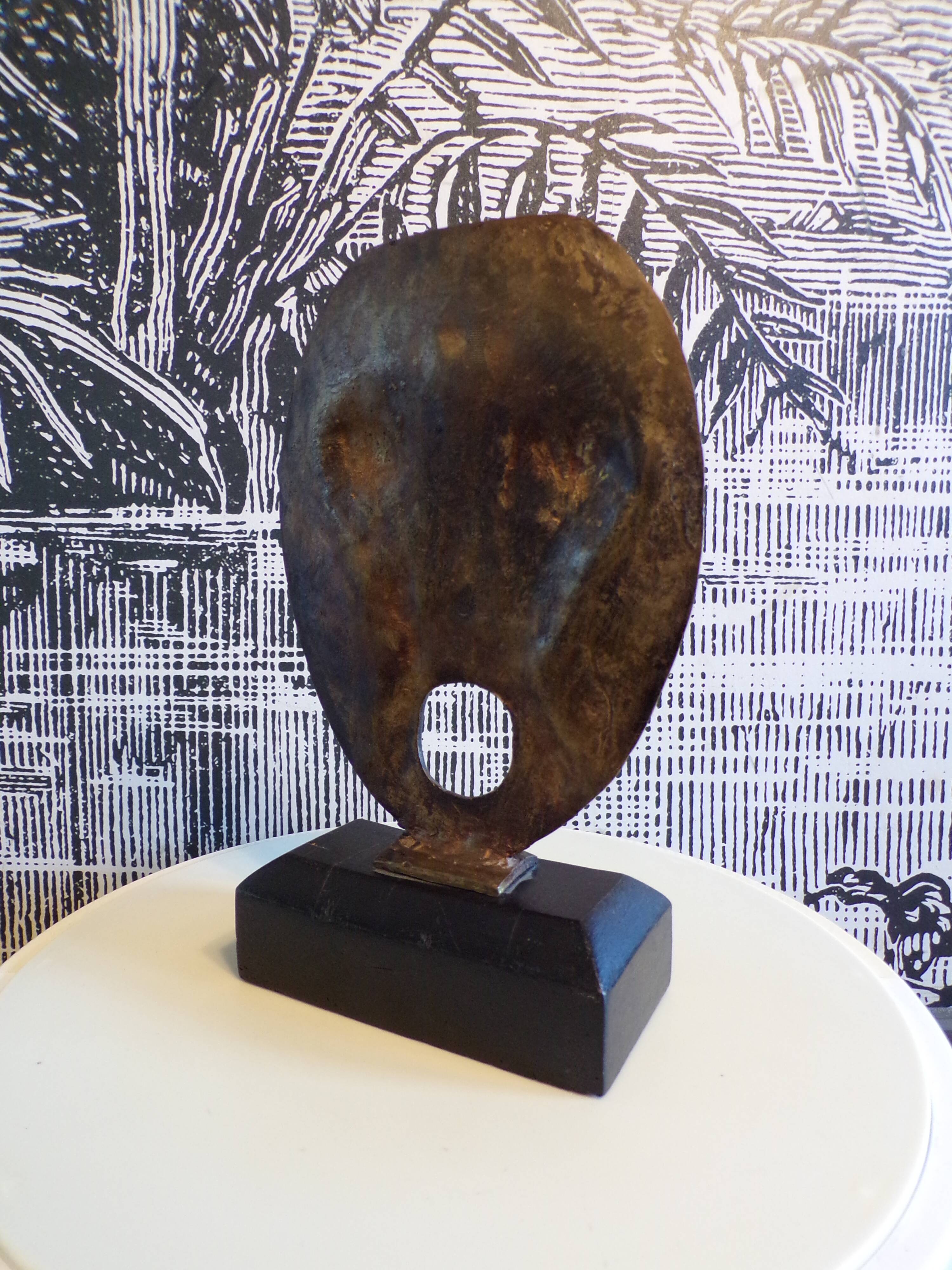 brutalist bronze face sculpture