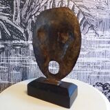 brutalist bronze face sculpture