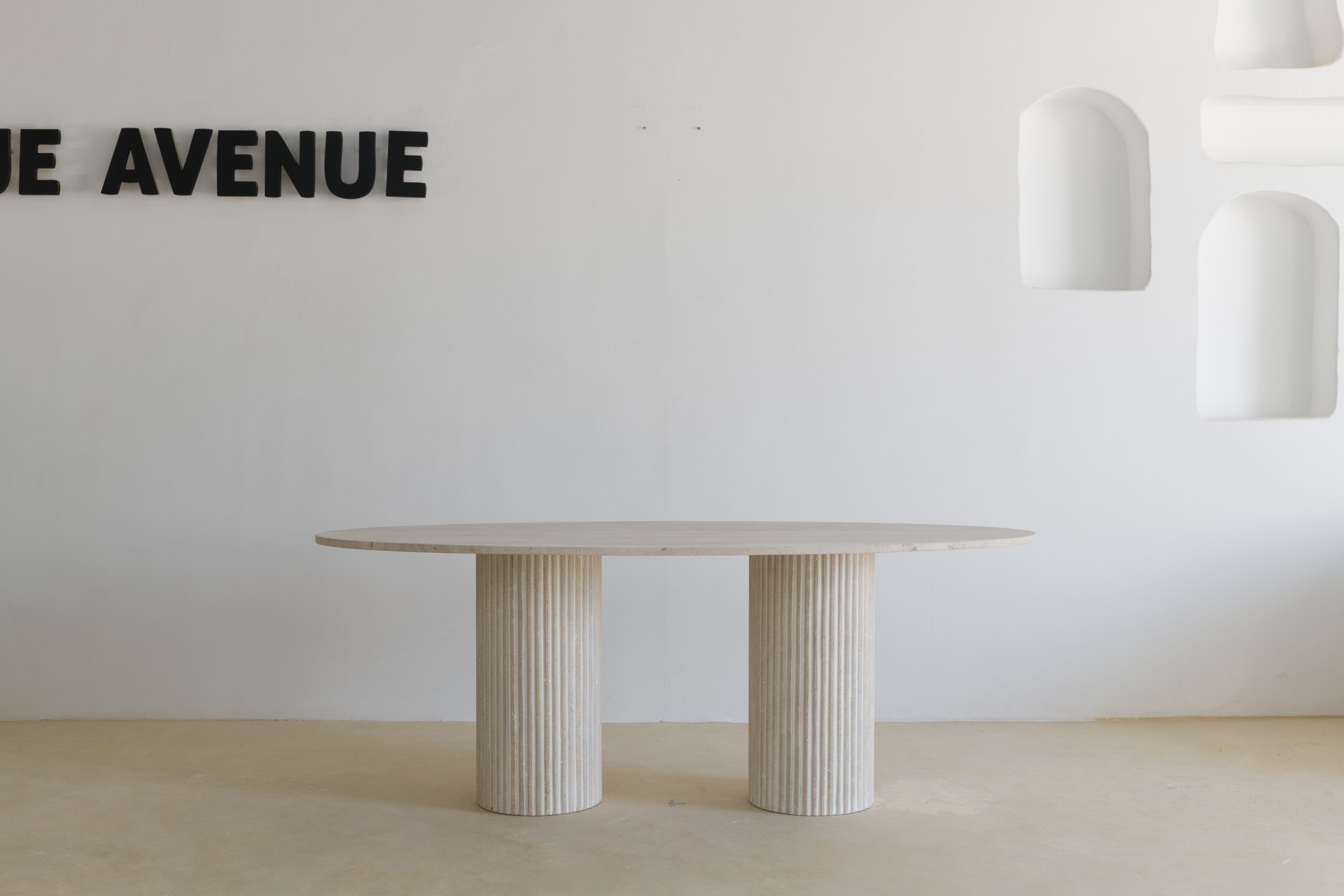 Natural travertine oval dining table - striated foot