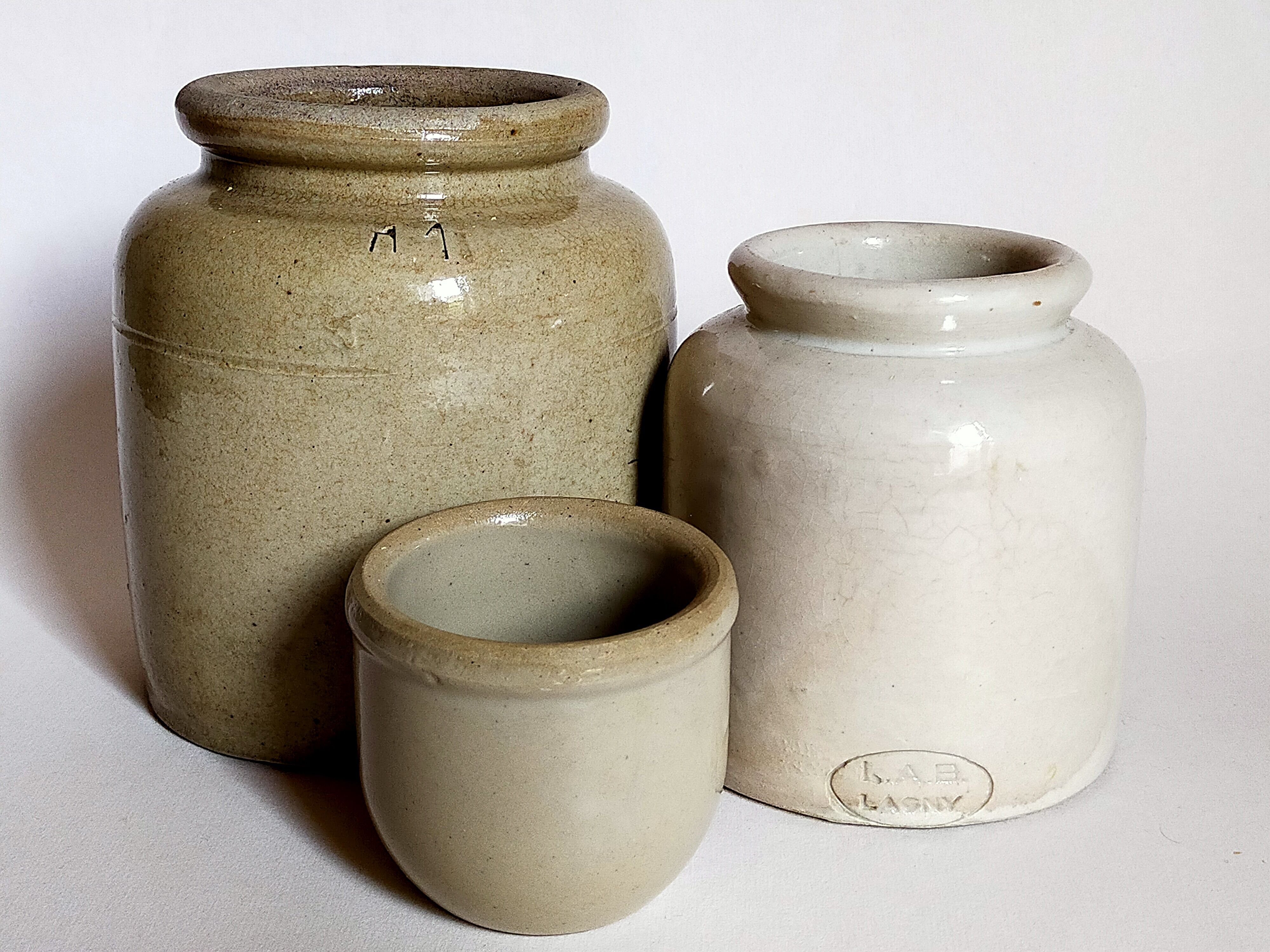 Set of three pots with old condiments in glazed earth