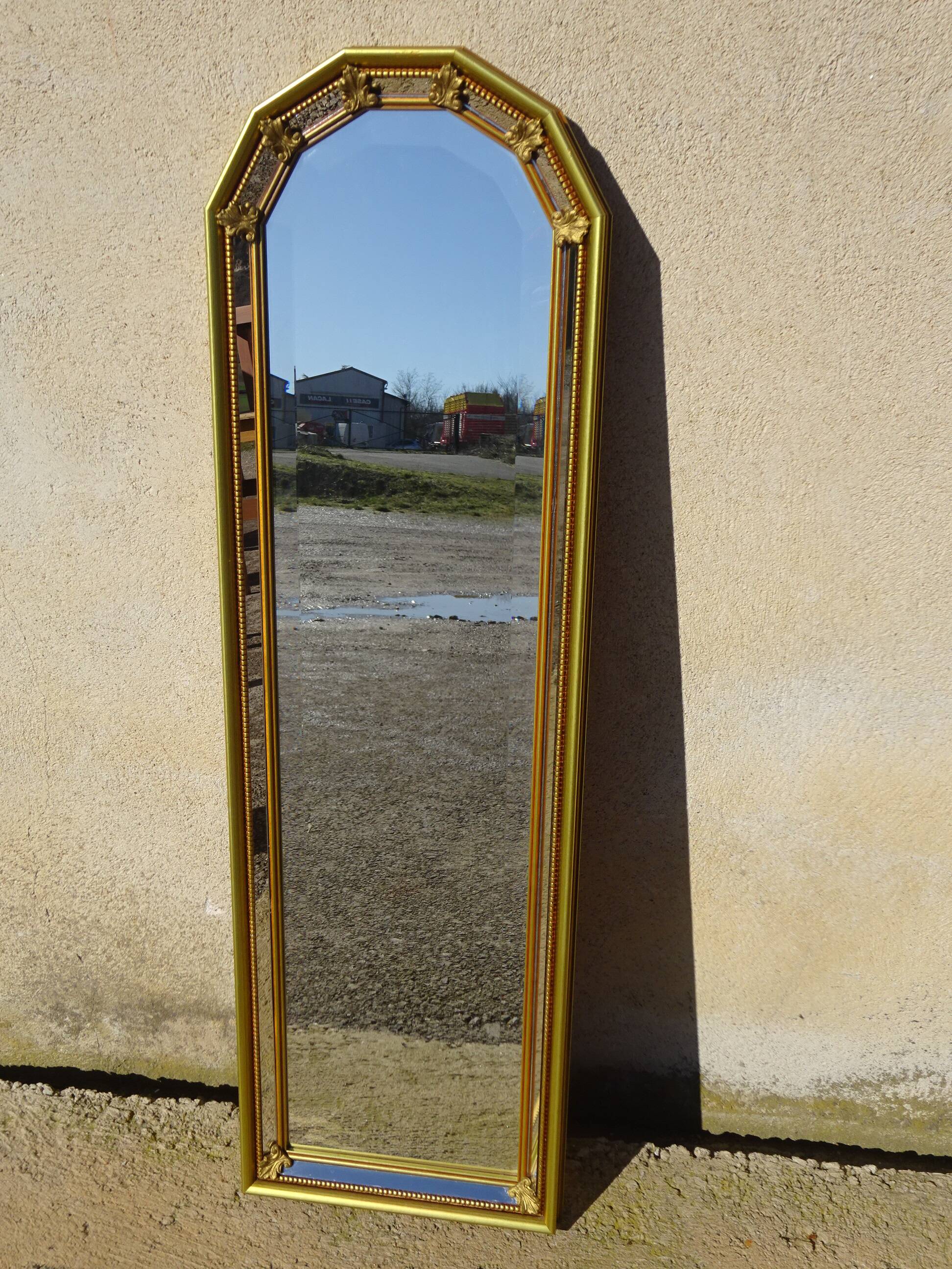 Vertical mirror, gold frame with beading.