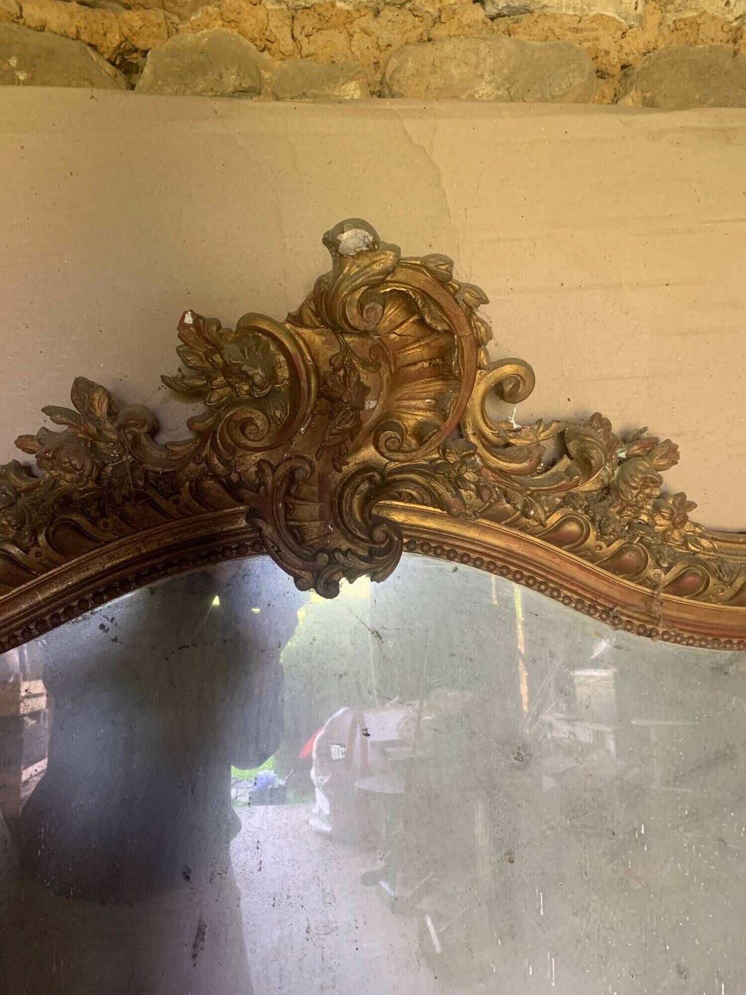 Large antique mirror in wood and gilded stucco.