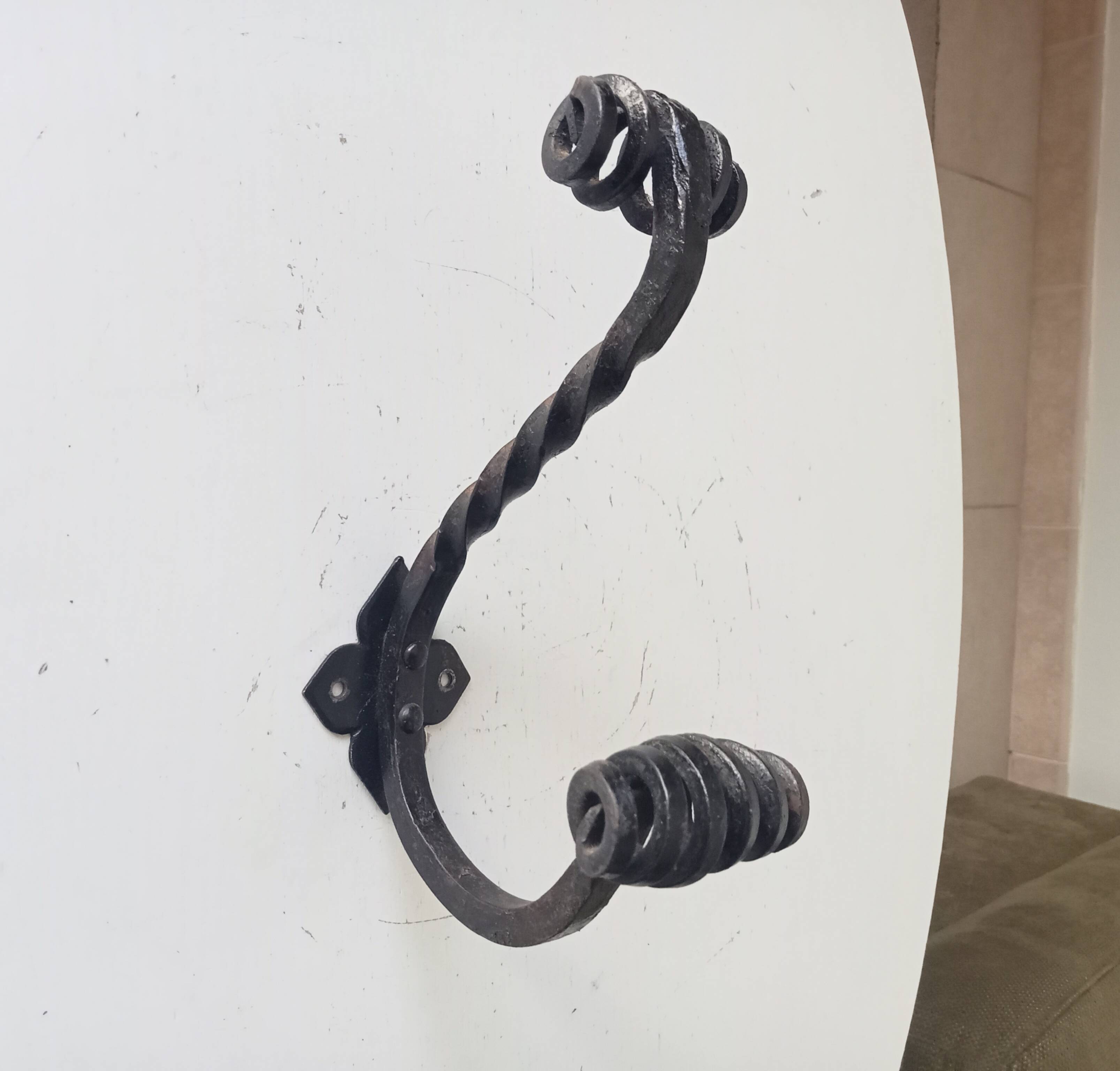 Brutalist wall coat rack in wrought iron.