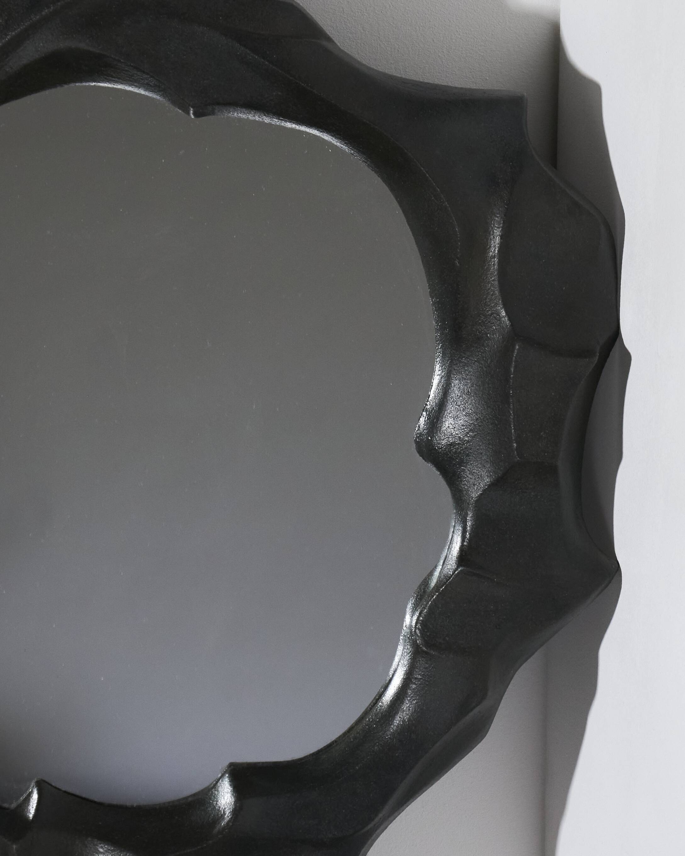 Sculptural sandstone mirror