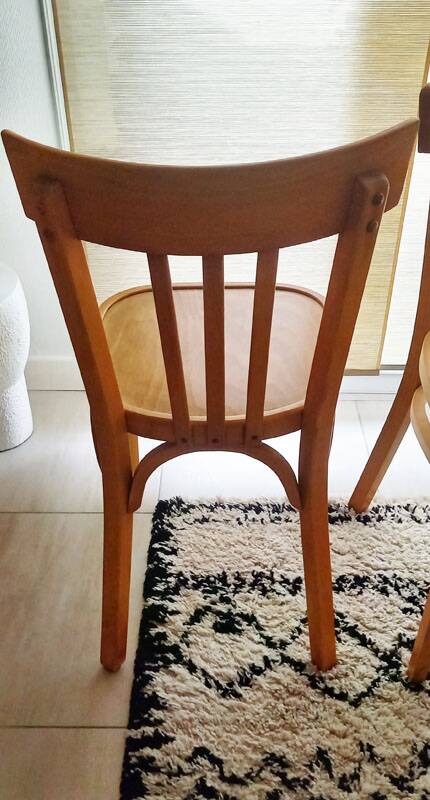 Set of 4 light wood bistro chairs stamped Baumann and Thonet.