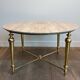 Brass coffee table with a white marble top.