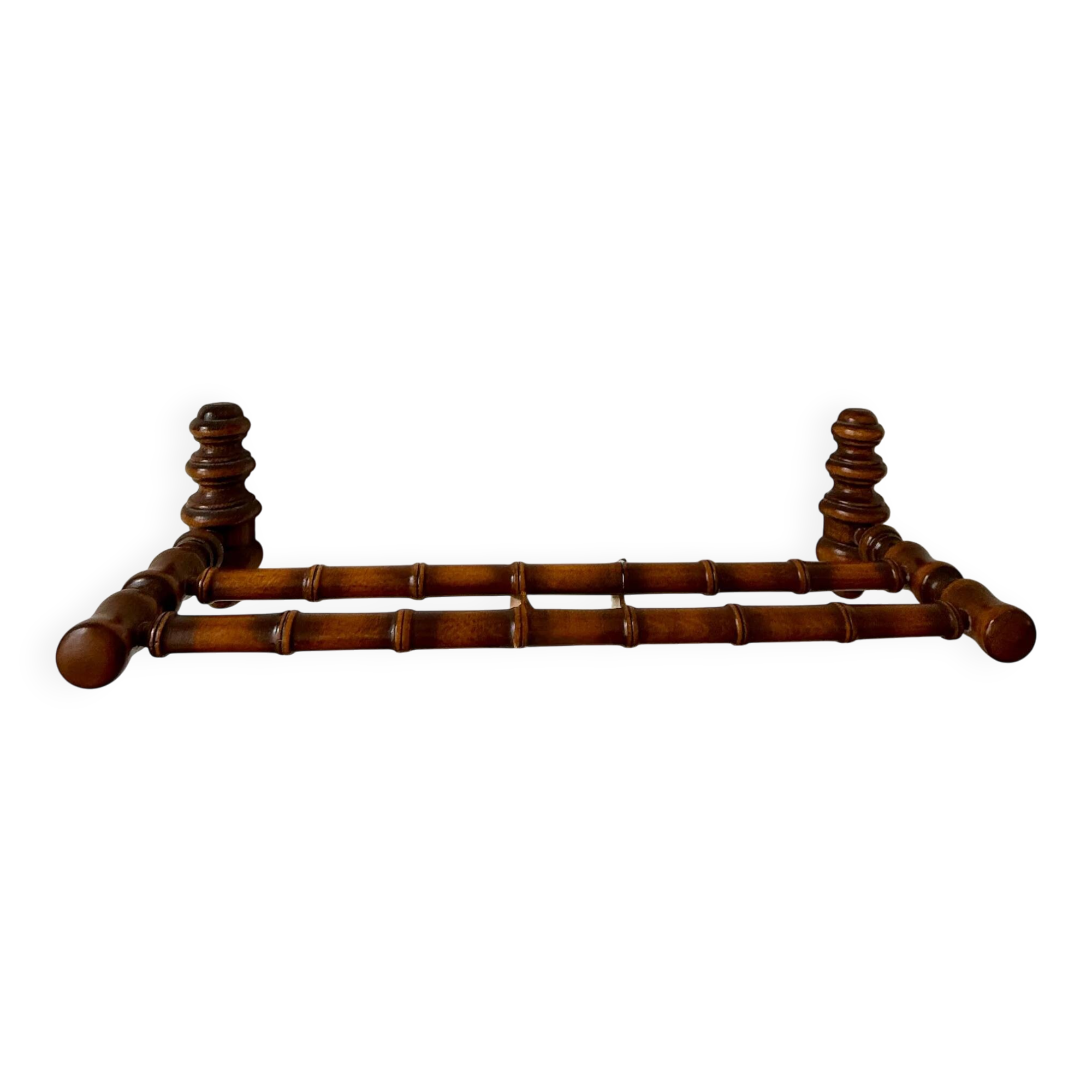 Wall-mounted coat rack made of turned wood in a bamboo style.