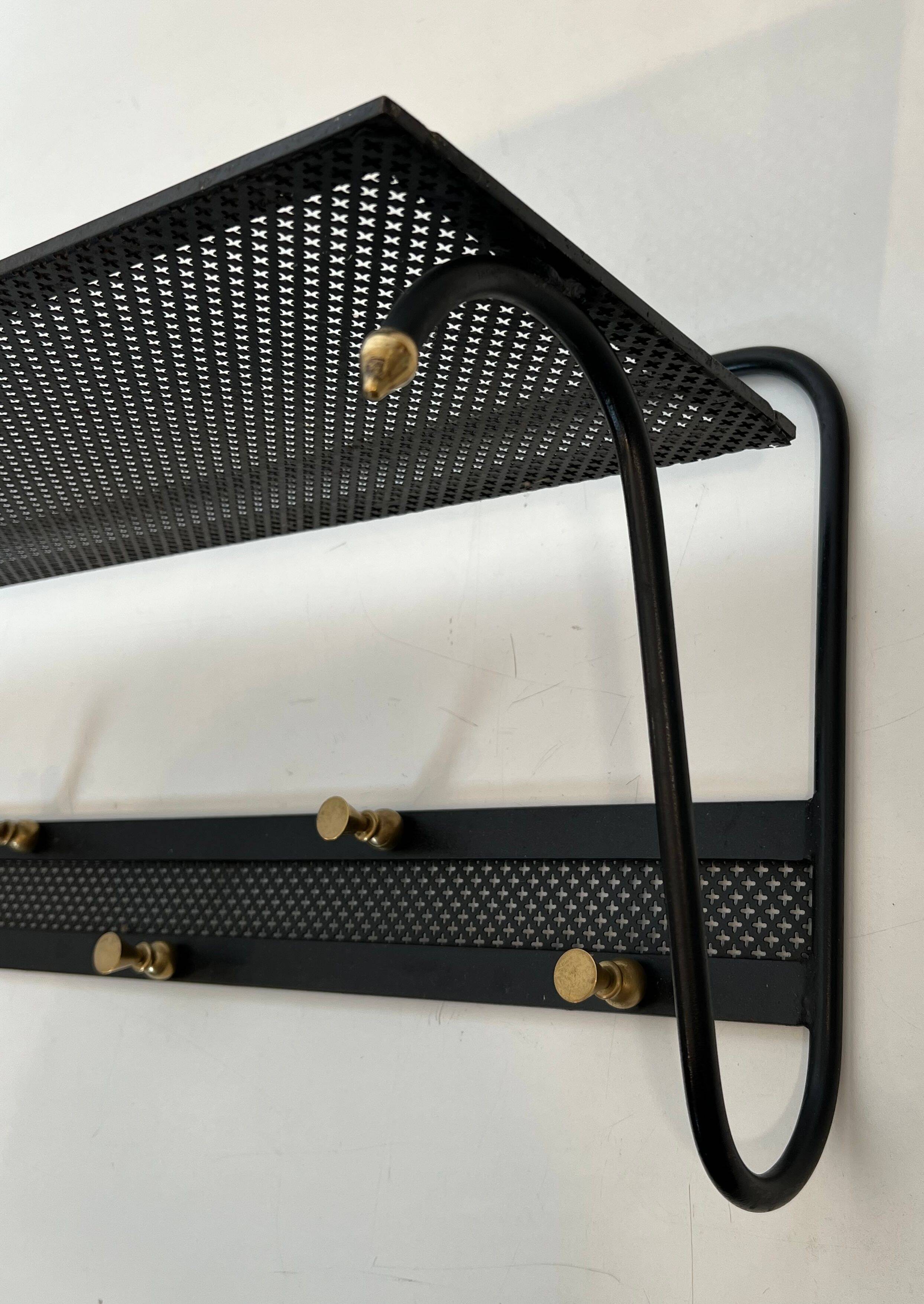 Coat rack in black lacquered metal, perforated sheet metal and brass in the style of Mathieu Matégot