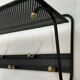Coat rack in black lacquered metal, perforated sheet metal and brass in the style of Mathieu Matégot