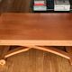 Wooden coffee table convertible into a dining table.