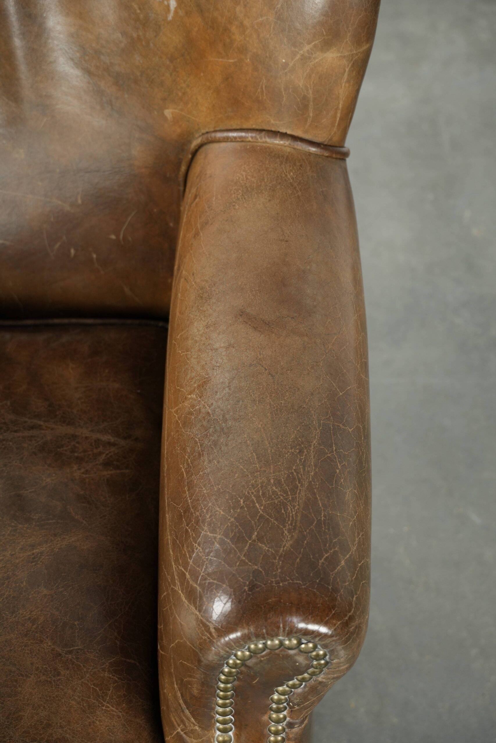 Robust cowhide armchair in a beautifully subtle size with a wonderful patina.