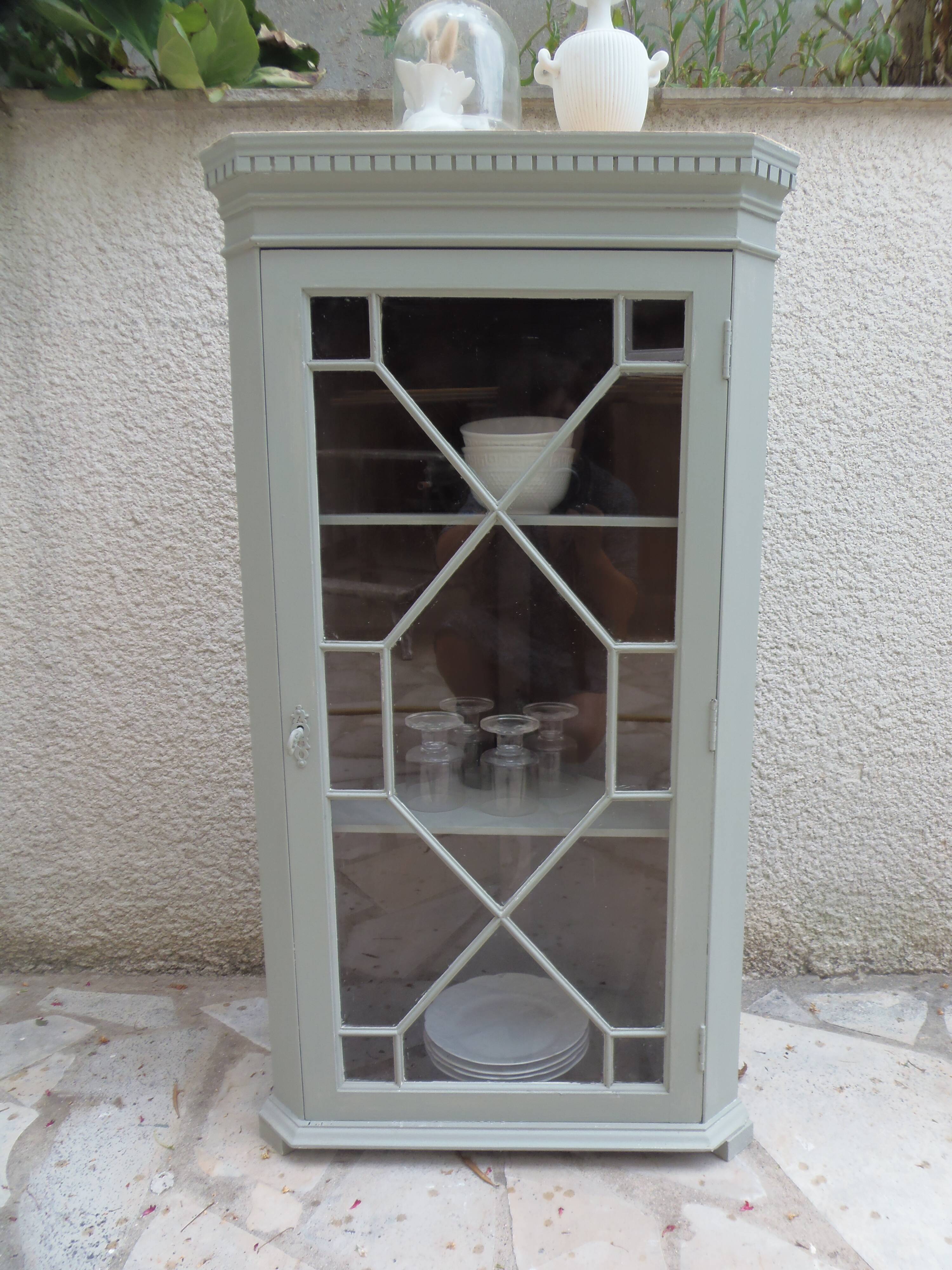 Vintage English corner display cabinet enhanced in grey-green with a wooden top.