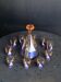 Liqueur set, pink glass carafe and 10 small sailboat-patterned glasses