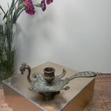 Chiselled brass candlestick in the shape of a peacock.