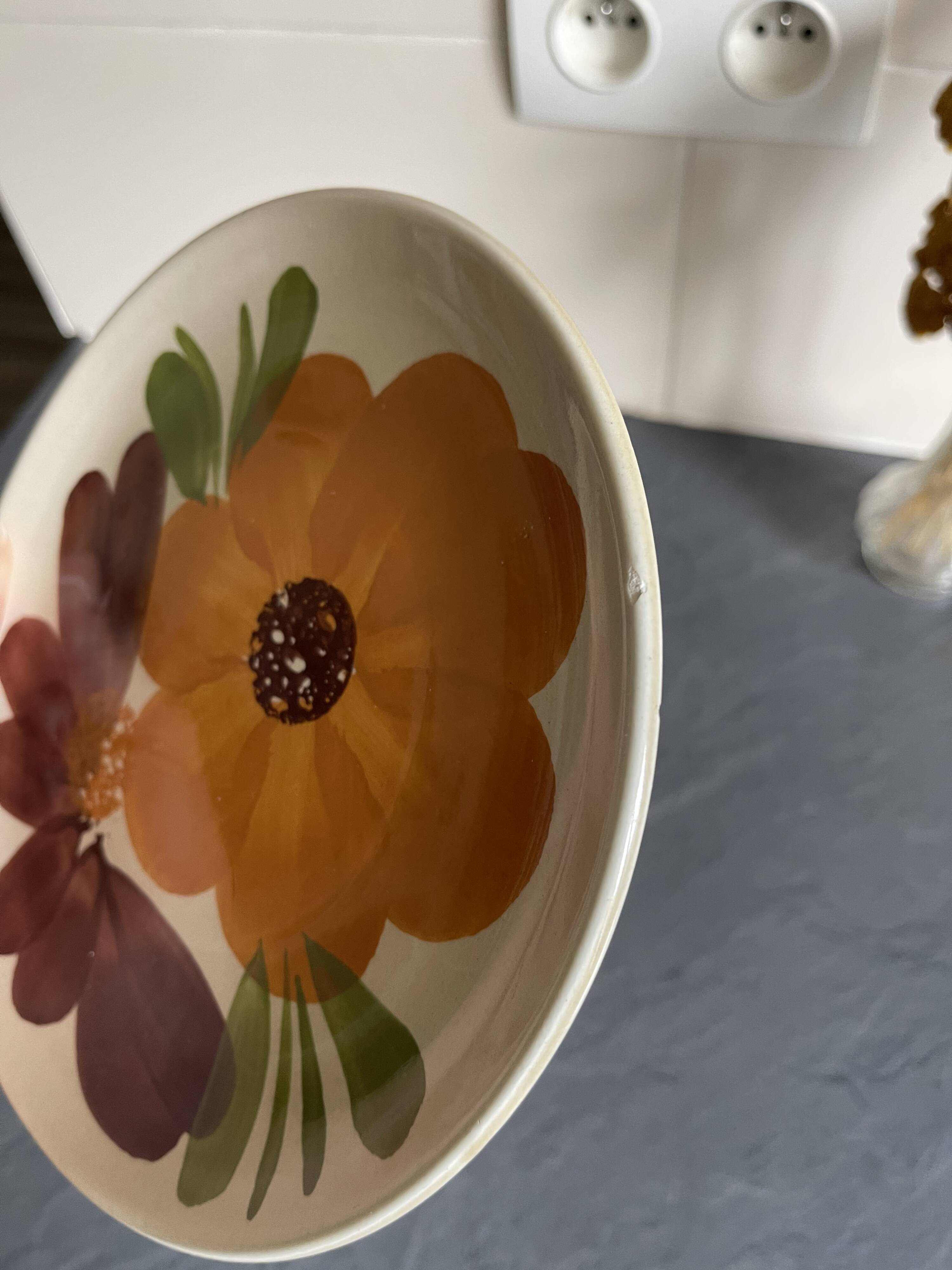Italian ceramic plates with floral fruit designs.