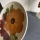 Italian ceramic plates with floral fruit designs.