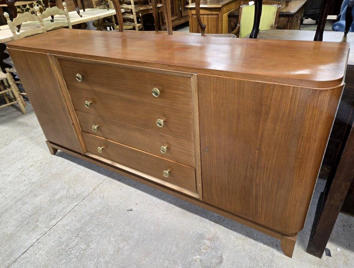 According to André Arbus, a sideboard in a row from the Art Deco period in blonde mahogany.