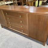 According to André Arbus, a sideboard in a row from the Art Deco period in blonde mahogany.
