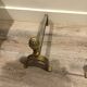 Neoclassical pine cone fireplace chenets in bronze
