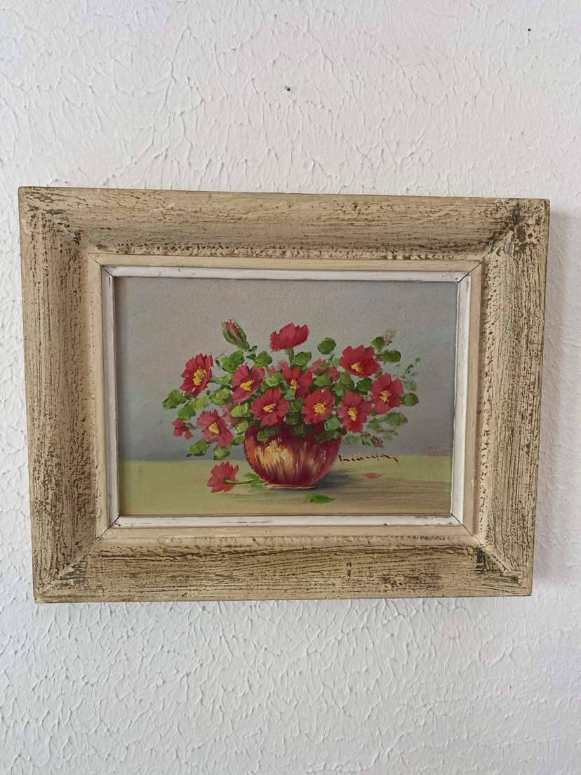 Painting red wild flowers in a vase.