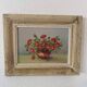 Painting red wild flowers in a vase.