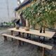 Antique French folding garden table set with benches, pine and chestnut, circa 1900–1920.