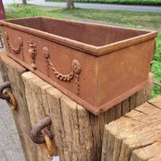 Rusty cast iron jardiniere planter