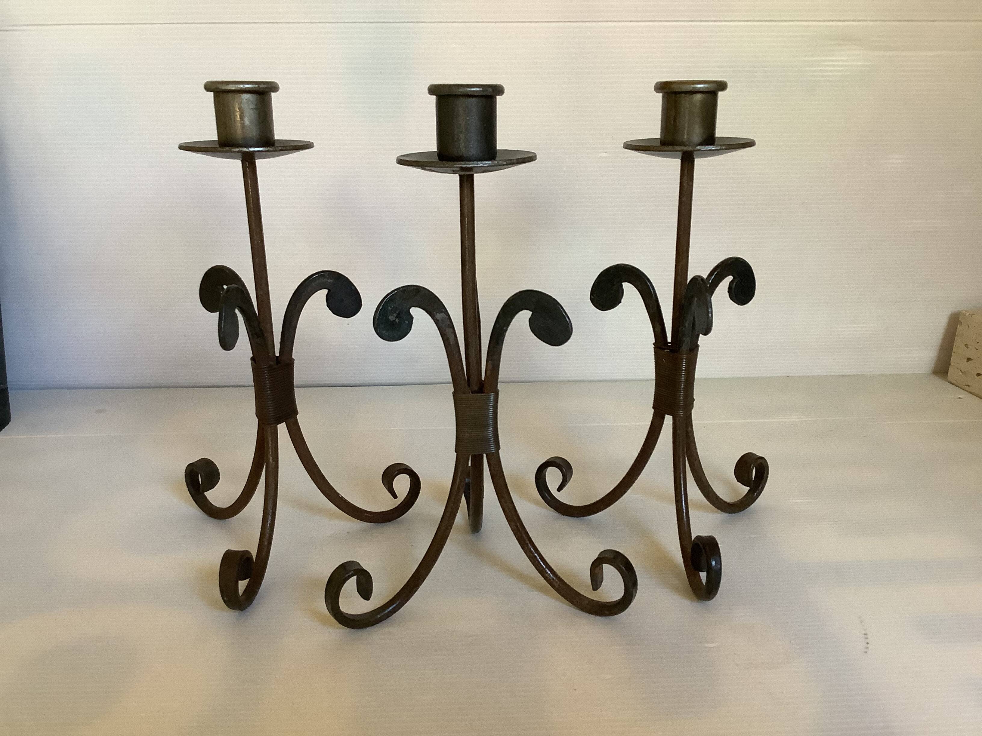 Trio of wrought iron candlesticks