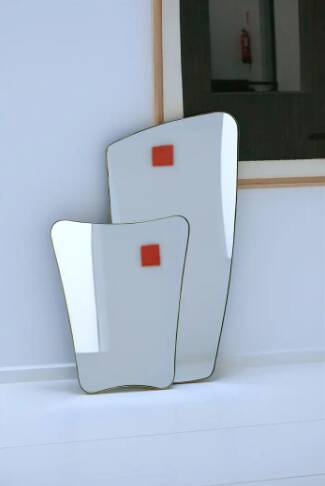 Contemporary rectangular mirror with rounded edges and embossed brass frame.