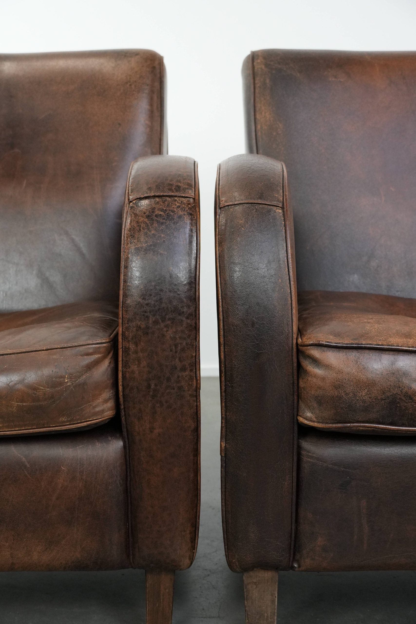 Set of two vintage sheepskin leather design armchairs in a cognac colour
