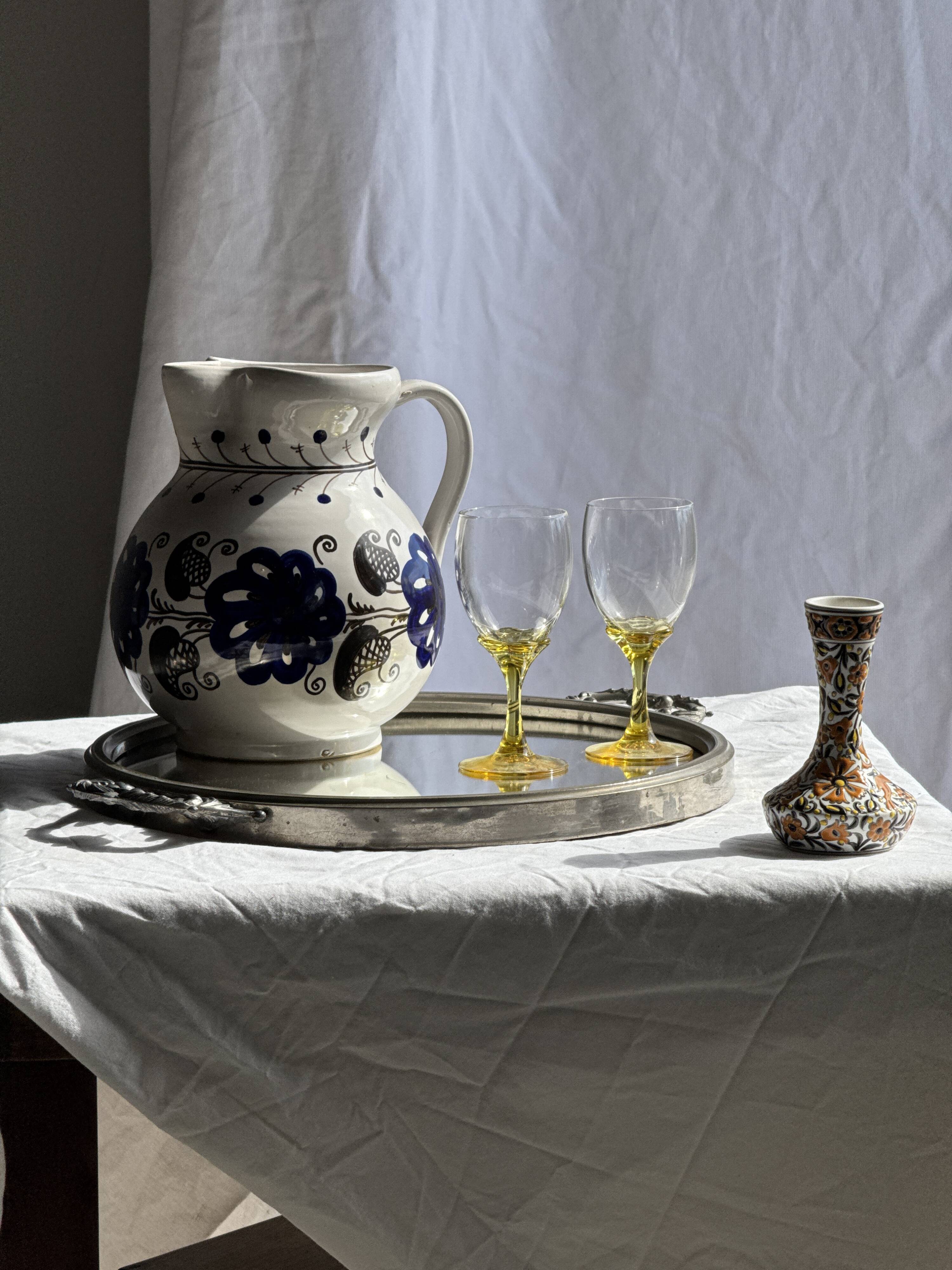 Very large vintage ceramic carafe in white glazed with blue floral decoration.
