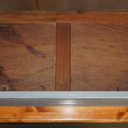 Vintage wooden furniture for 45 wine bottles with a drawer.