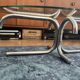 Oval glass coffee table with chrome legs, vintage 70s design.