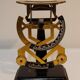 Former weighs metal letter