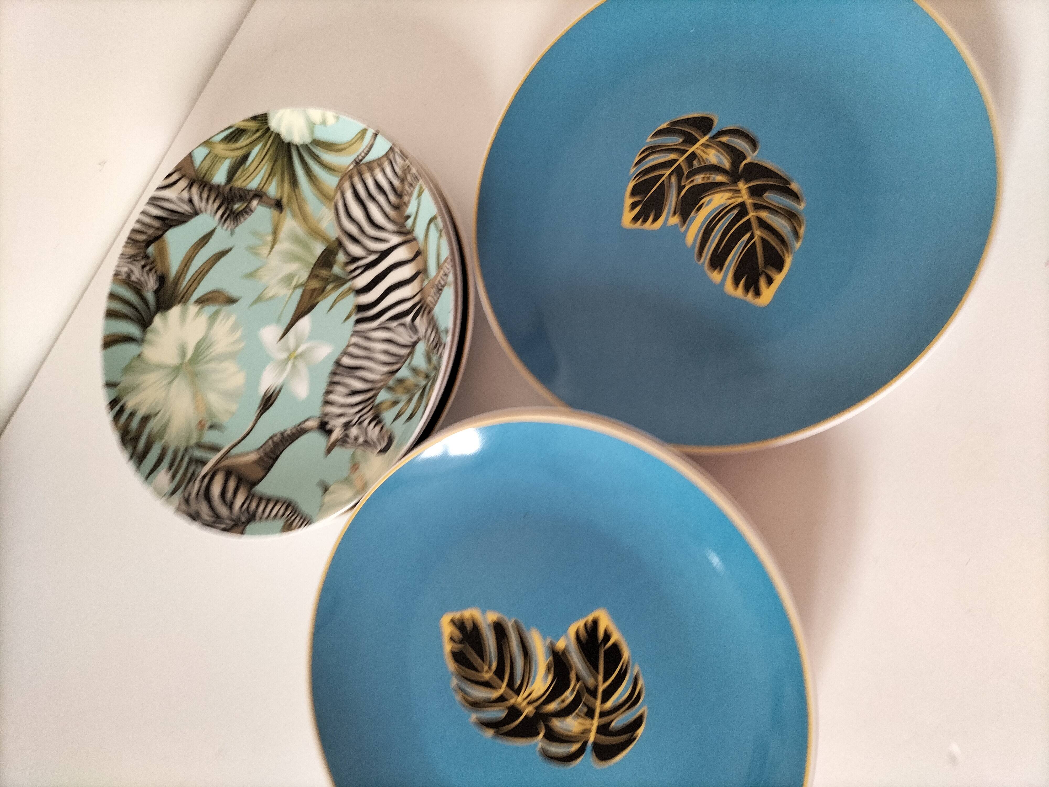 Set of 7 porcelain plates, gold foliage & jungle
