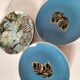Set of 7 porcelain plates, gold foliage & jungle