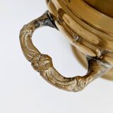 Vintage brass cache-pot on a stand with handles, classic decor.