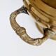 Vintage brass cache-pot on a stand with handles, classic decor.
