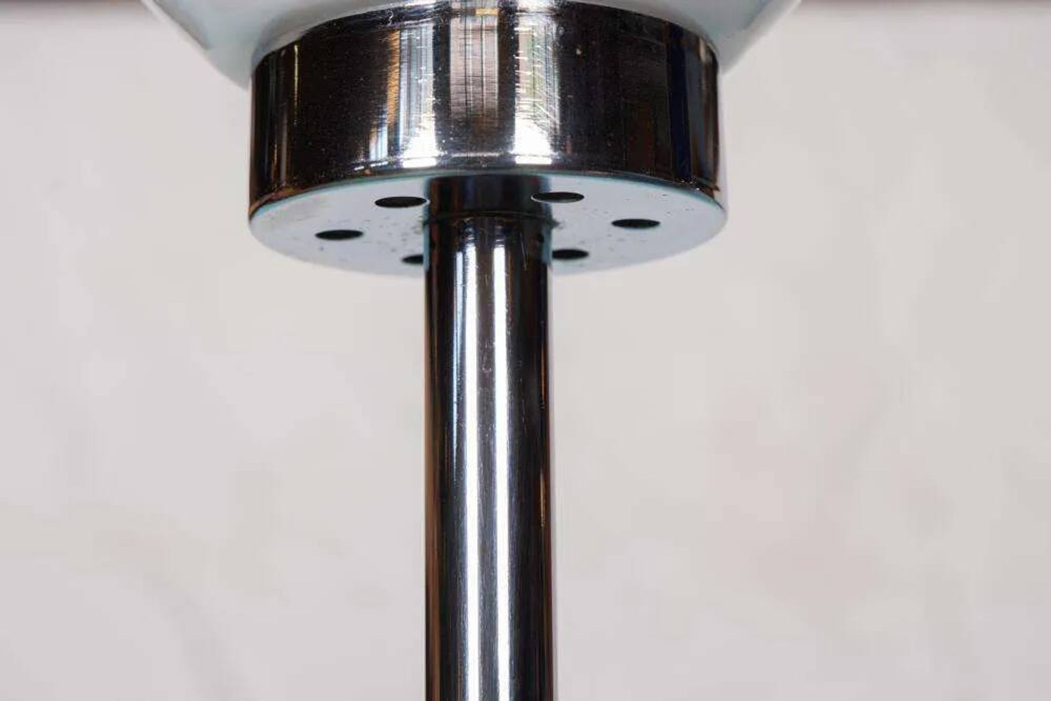 Vintage floor lamp in milky glass and chrome, minimalist uplight lighting.