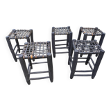5 blackened wooden stools with woven leather seats by Nina Kaufmann