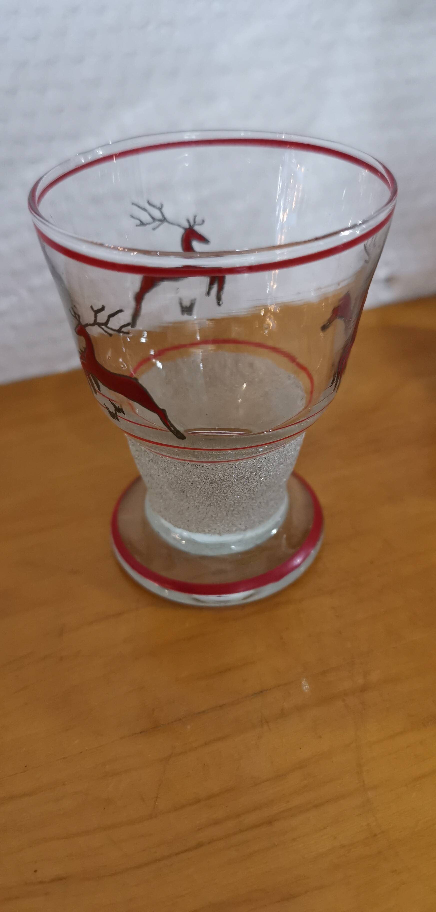 Glasses and carafe decorated with red Christmas reindeer and white granita 60's