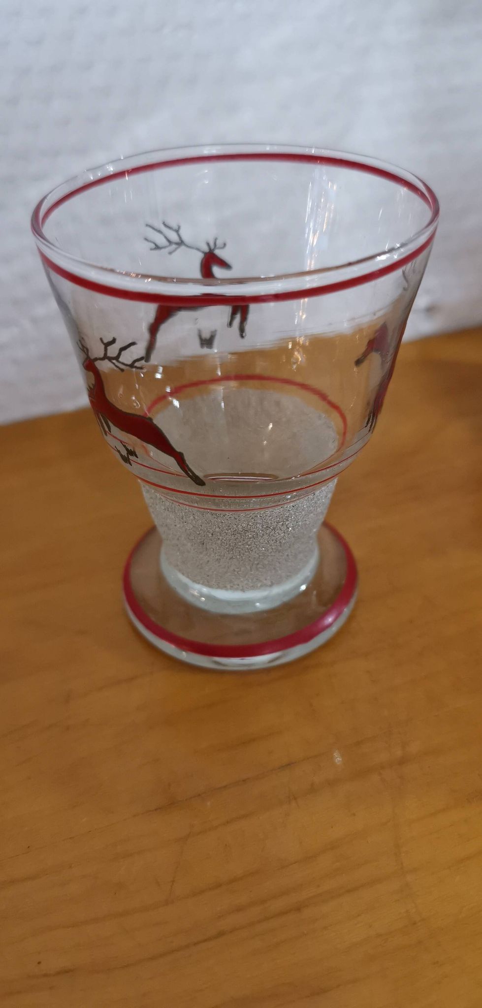 Glasses and carafe decorated with red Christmas reindeer and white granita 60's