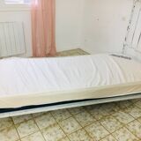 Old white metal and brass bed