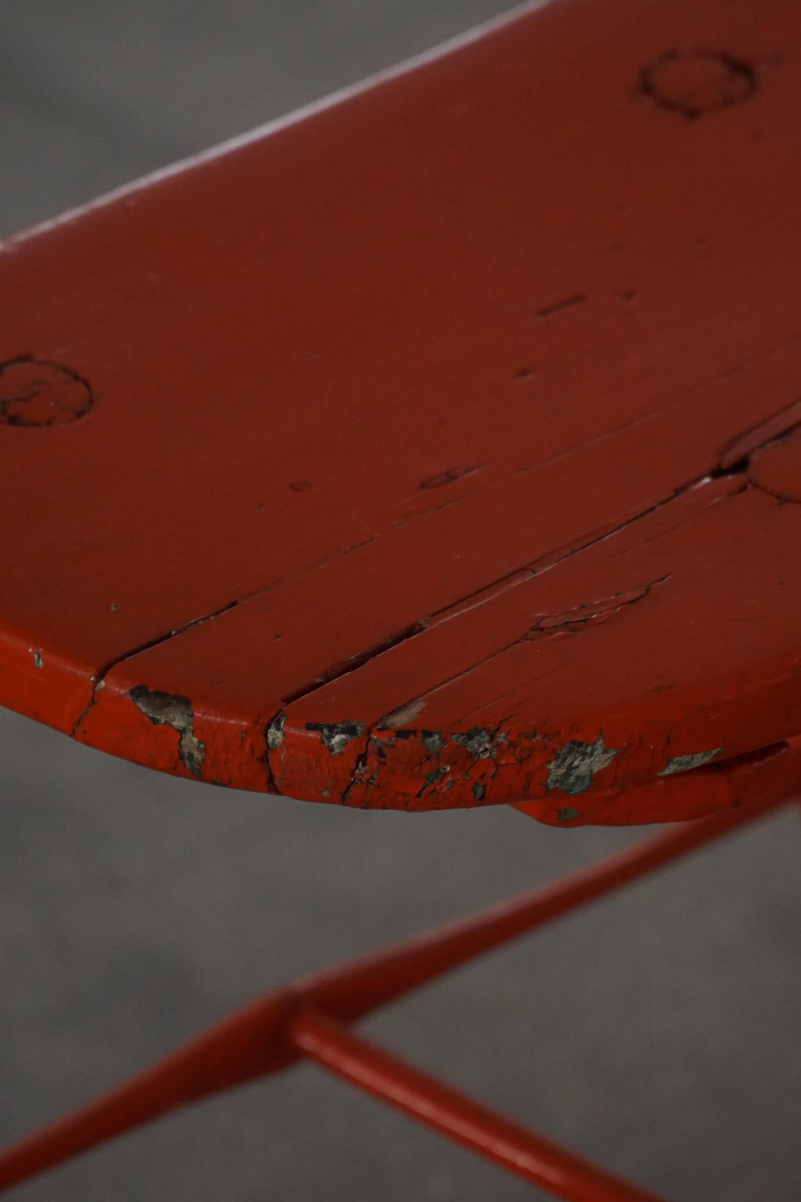 Pair of patinated wooden stools painted red with flared legs, 1950s-1960s.