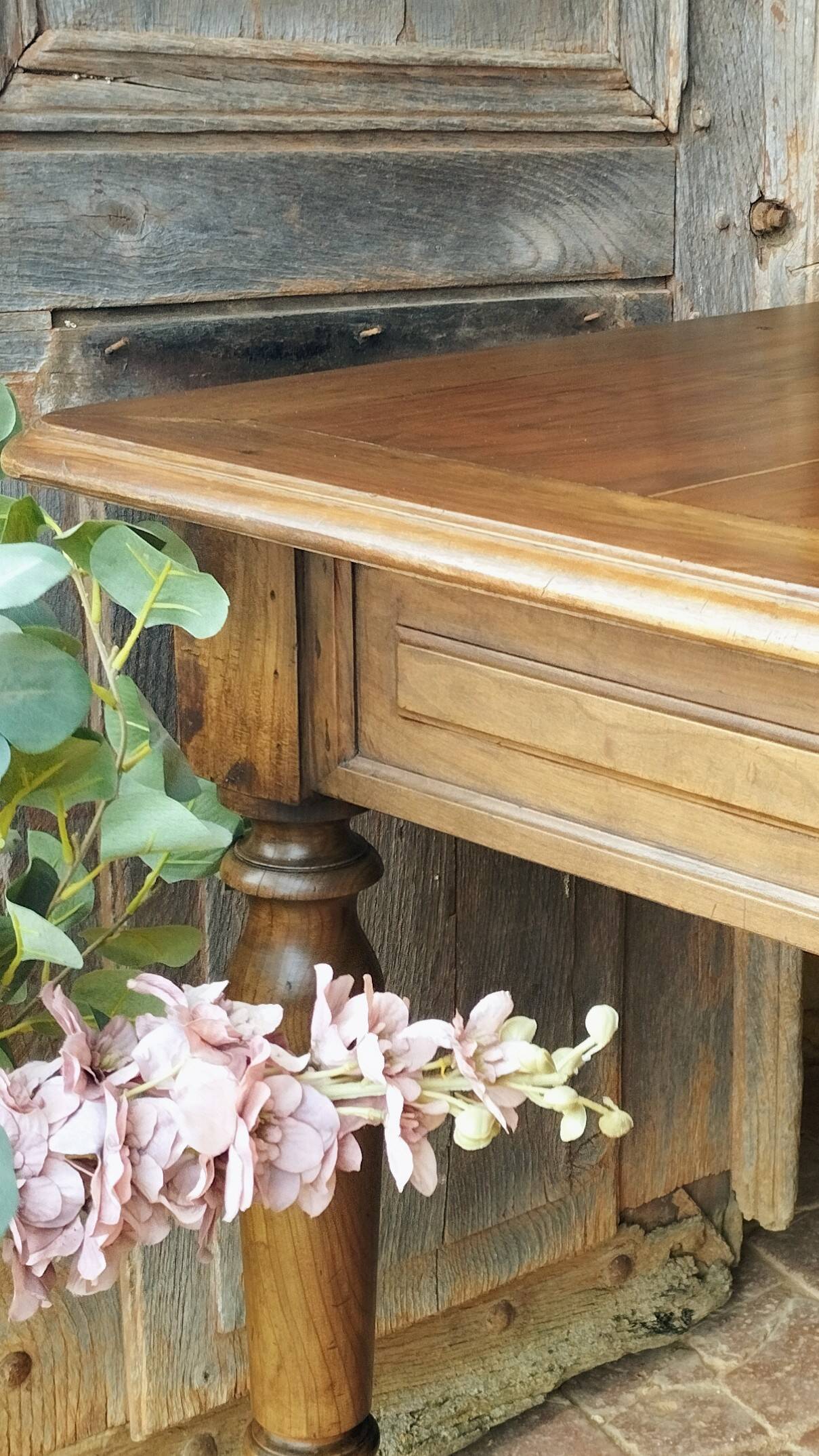 Old French farmhouse table in walnut with turned legs.