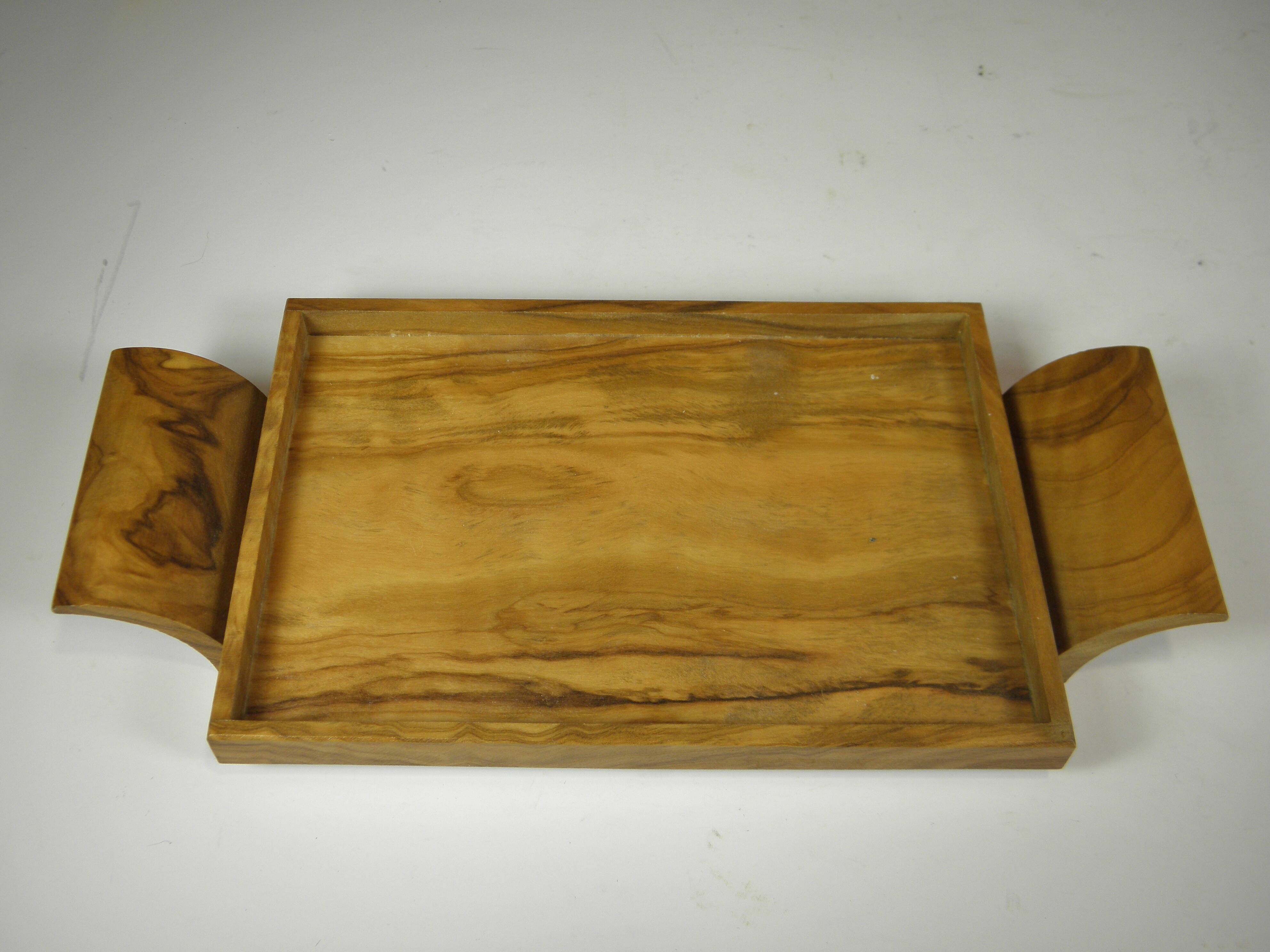 Six egg cups on a wooden tray.